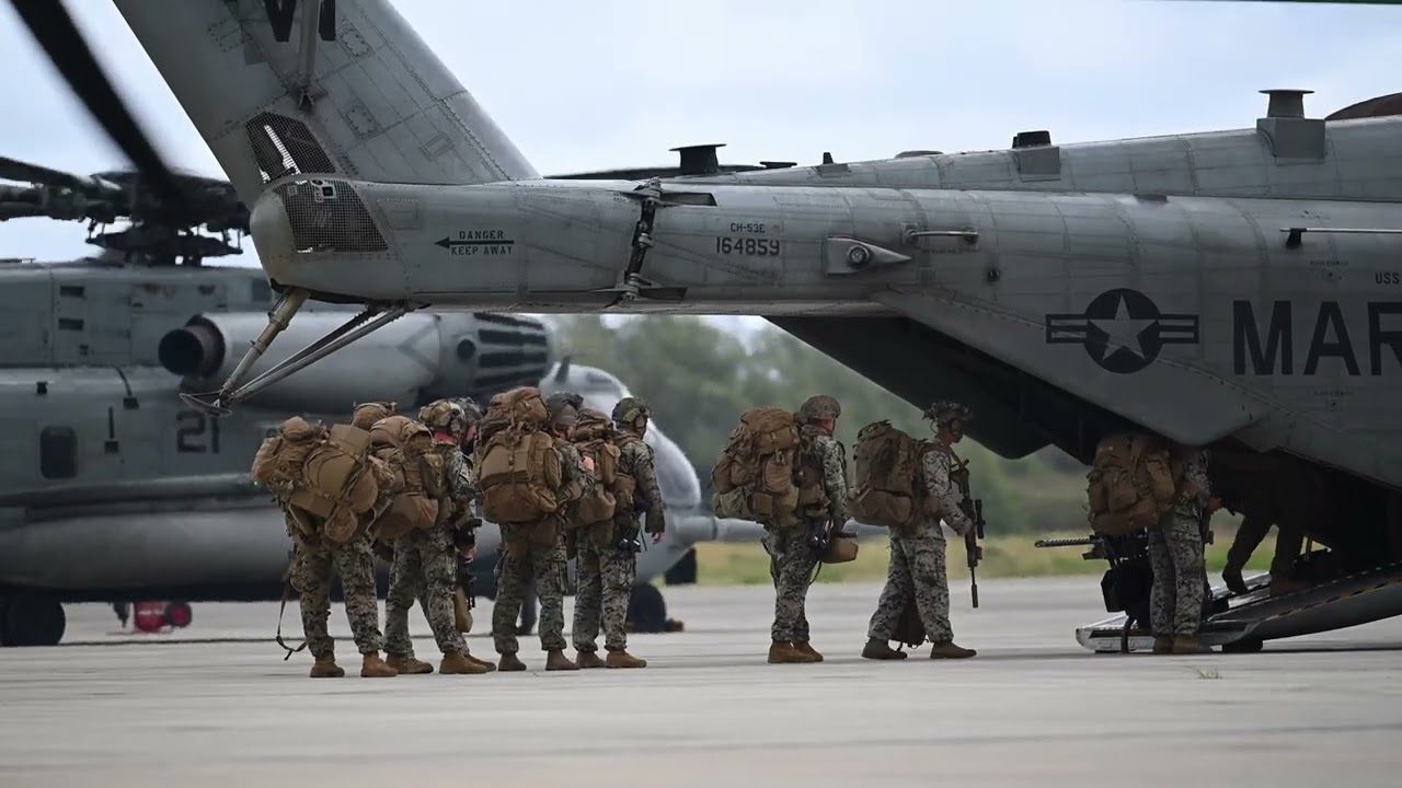 U.S. Marines board a CH-53E Super Stallion attached to Marine Medium Tiltrotor Squadron