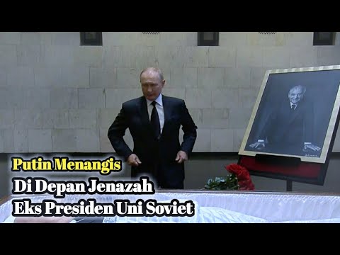 Vladimir Putin lays flowers next to open coffin of Mikhail Gorbachev