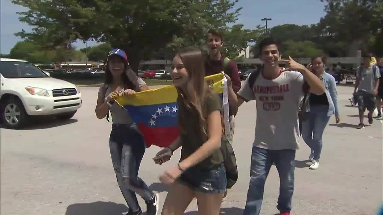 Students of all nationalities show pride at J.P. Taravella High School after flags allegedly tak...