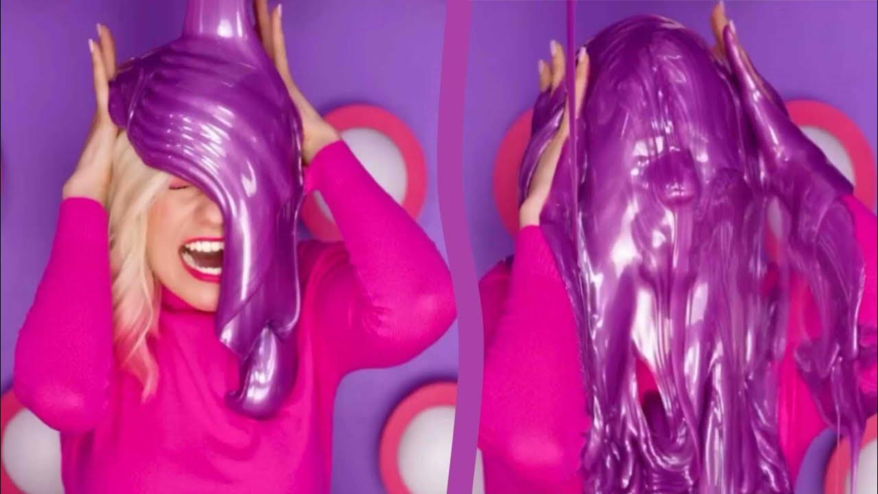 CC1 - Harley Quinn hair gunged with sticky purple glue slime - A clip from a colourful channel, with a young woman with Harley Quinn hair getting gunged with sticky purple glue slime while sitting in a mystery buttons box.