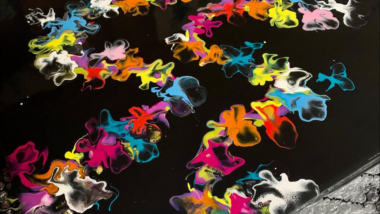 Acrylic pour, with vibrant colours on a black background.