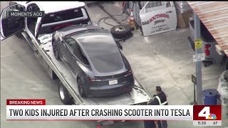 Two kids on scooter crash into Tesla in Orange