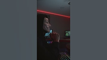 Person in Guy Fawkes Mask Using Computer