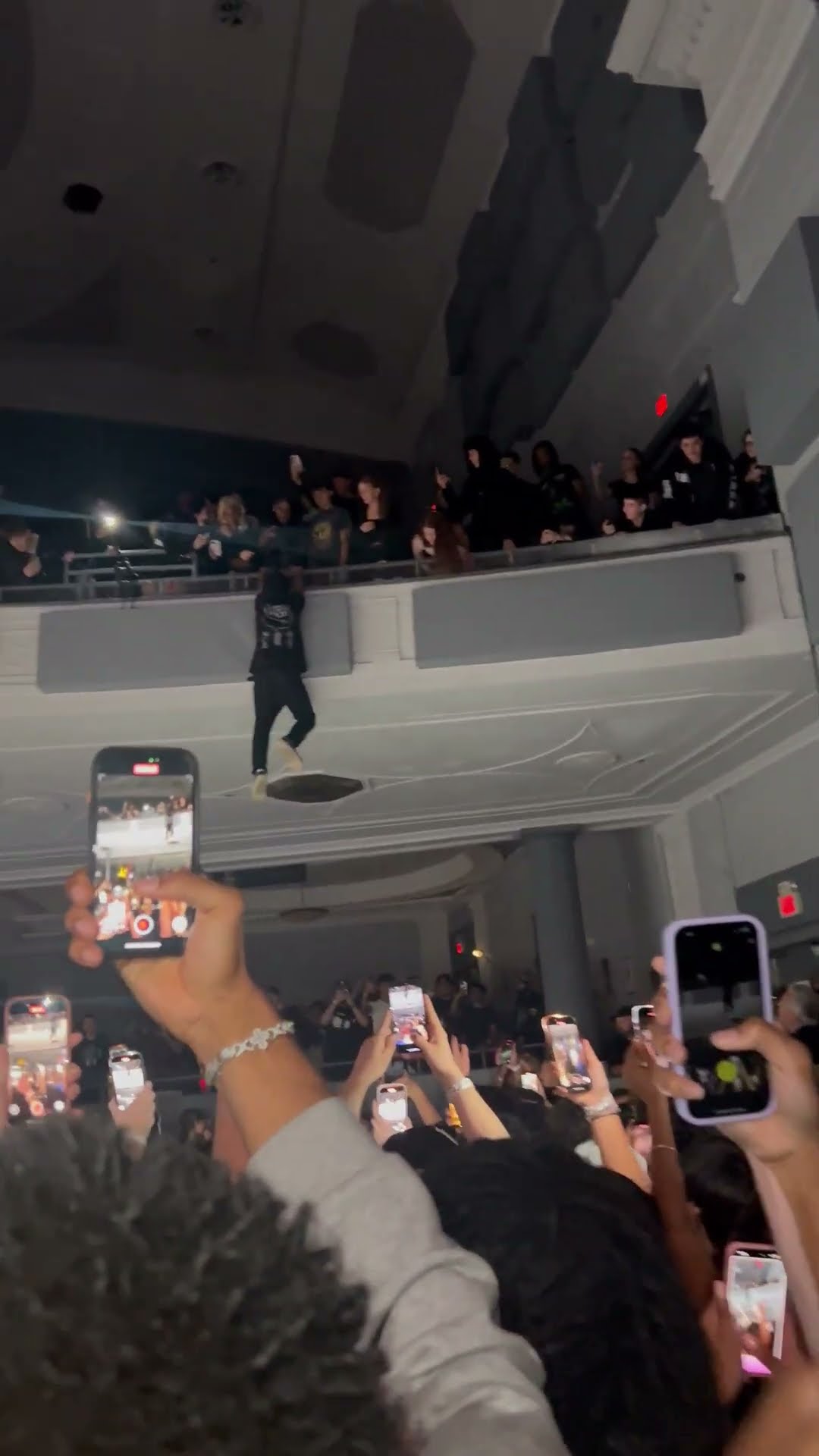 Man Struggles to Climb Back After Failed Concert Pit Jump