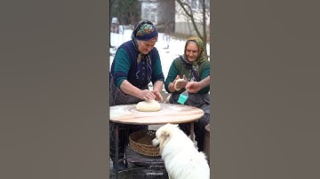 439 – “Turkish Grandparents and Dog Baking Bread in Clay Oven”