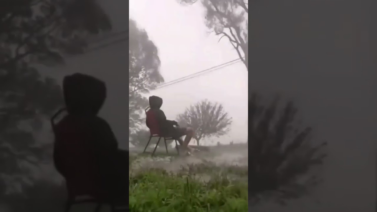 the boy is sitting alone in the rain 