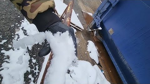 Removing Snow From Old Rusty Security Rail