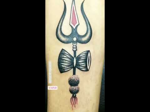 181 Tattooz Studio  A small design of Trishul with damroo on wrist with  slight shading in damroo One of the best small tattoo designs of Trishul  one can get inked For