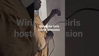 wiring works , putting lights in the Girls Hostel extension at Kasese Humanist School