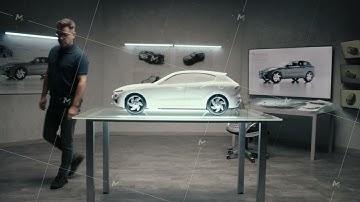 Automotive engineer develops a prototype model car in a modern studio of company