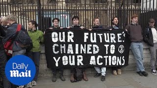 Young climate change activists chain themselves to Parliament railings