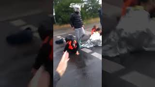 Woman chases eco protester trying to film activists blocking traffic