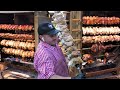 Germany Street Food in Italy. Huge Grills with Pork Legs Skewers, Burgers, Sausages. Sud Tirol