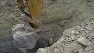 Excavator Ripping Rock