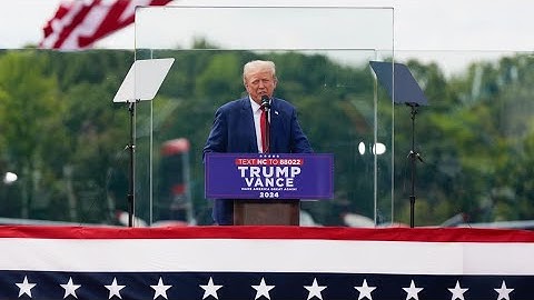 Trump speaks from behind bulletproof glass at first outdoor rally since his attempted assassination
