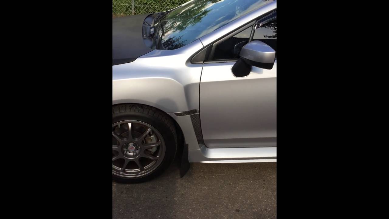 Carbon fiber vinyl wrap hood on a WRX