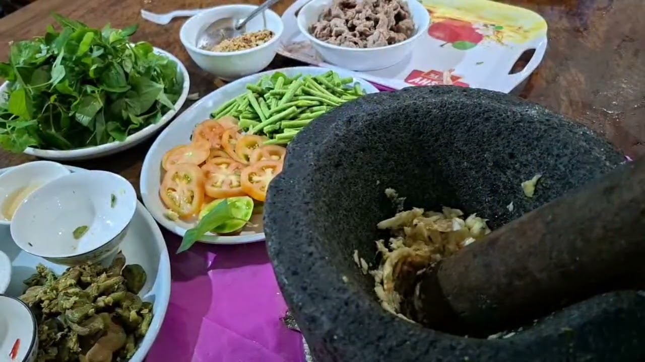 Cambodian food- a mixture of vegetables, herbs, beef and crushed tamarind ￼