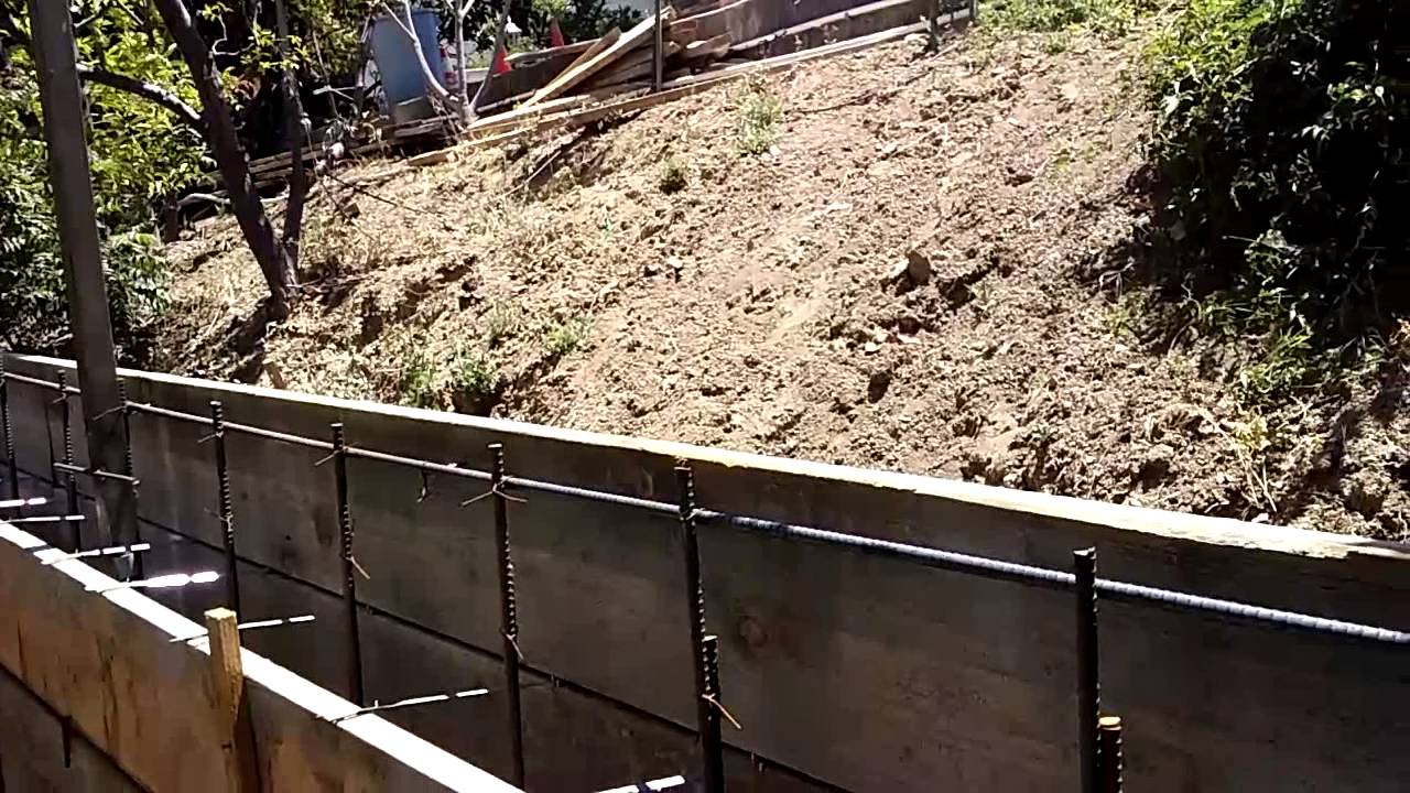 Veterans concrete,...embedded elec. conduit & fence post ret. wall