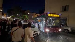 Roma fuori controllo: bus Atac bloccato dalla sosta selvaggia, folla esasperata sposta di peso auto