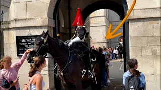ANGRY king’s guard shouts loudly at the tourists while they STAND at HORSE BACK door
