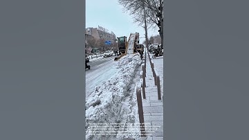 Snow Removal Machine in Action: Clearing City Streets After a Blizzard