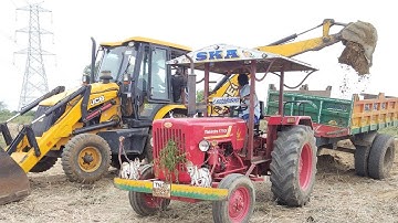 Mahindra 575 Di Tractor fully loaded with trolley and 3dx JCB machine working in tractor media