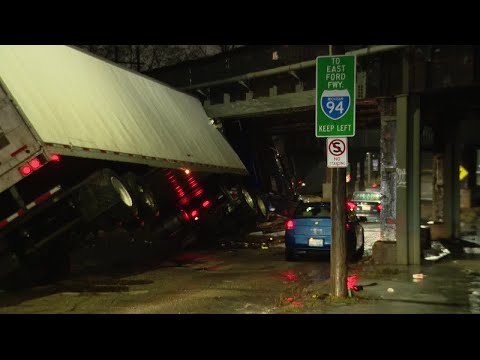 Semi-truck hits train overpass in Detroit