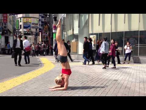 yoga-at-shibuya-crossing,-tokyo-japan:-pinchamayurasana