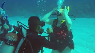 Female Scuba Diver Adjusts Mask