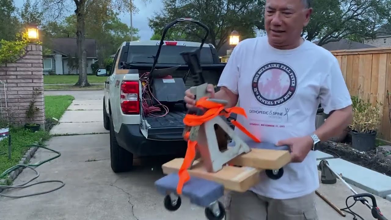Loading Lawnmower on pickup truck.