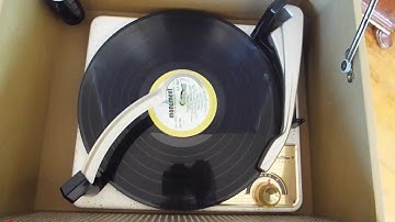 Silvertone record player playing a 33.3  RPM LP record.