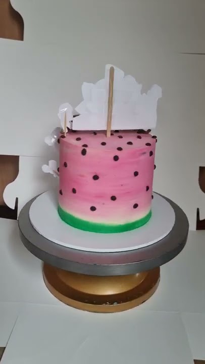 cocomelon theme 1st birthday cake in pink with whipped cream