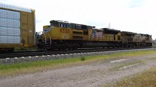 UP 7858 and UP 8520 lead a autorack train west through Dekalb IL