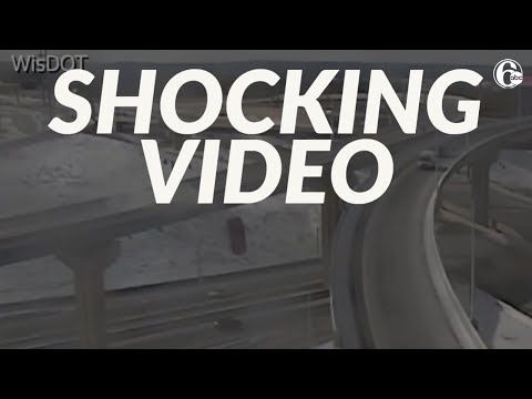 Driver survives 70-foot plunge after skidding off highway barrier wall | SHOCKING VIDEO