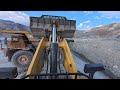 Komatsu WA900-8 Loading Belaz Haul Truck with Mud on Uneven Ground