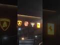 Ferrari Bugatti Tesla and random card in showroom