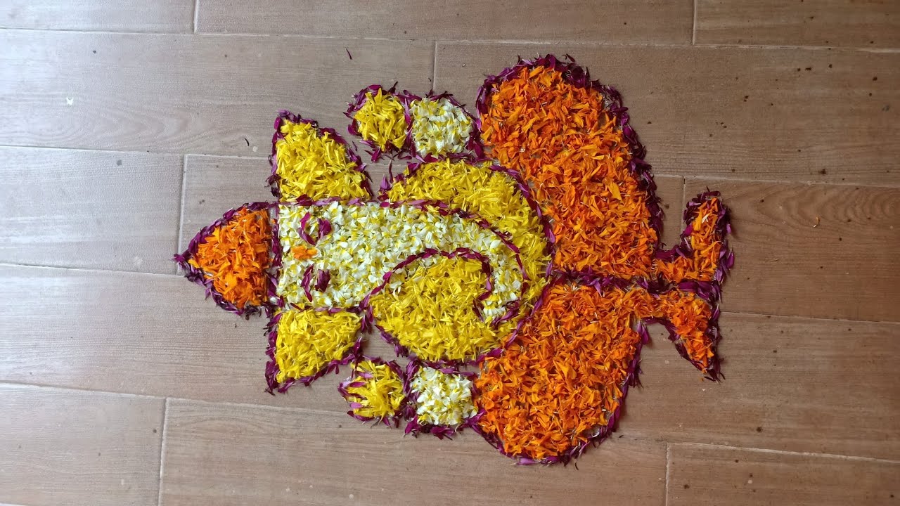 Lord Ganesh rangoli design in marigold flowers by Janya's creation ...