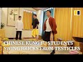 Swinging bricks from our testicles makes us strong, Chinese kung fu students say
