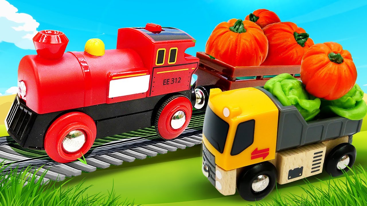Toy BRIO train on the wooden railway brings harvest to the city Play