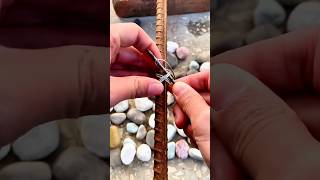 Binding metal rods with wire and a nail to secure them firmly and prevent loosening in use