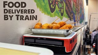 Japanese Food Arrives on Train Conveyor Belt