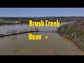 Brush creek on Beaver Lake still muddy with debris floating everywhere.