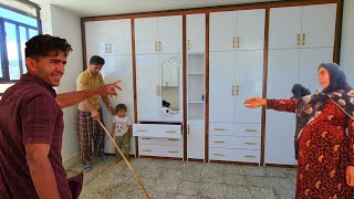 Installing a wooden closet in a country house.  Hassan installed a beautiful wardrobe