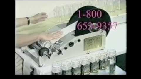 Race 3100 RL-1 Original Race Label Machine Applying Labels to Round Containers from a Conveyor Belt