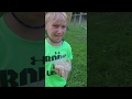 Boy gets spit in the face while feeding llama
