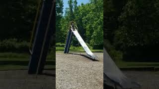 Boy climbs to the top then falls backwards down ladder of slide