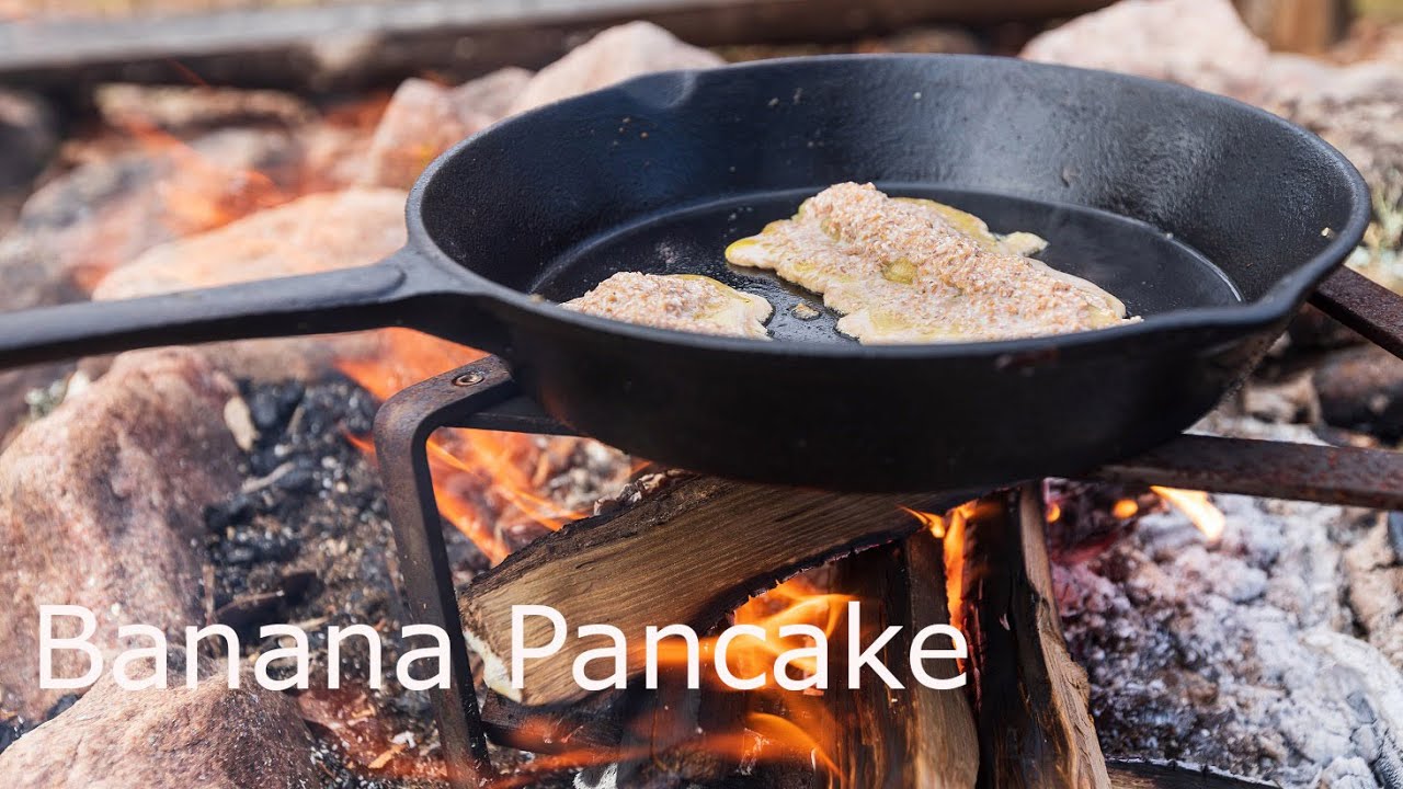 Banana pancake cooked on the campfire. ASMR
