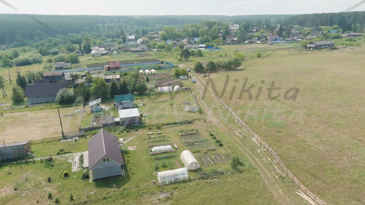 Russia, Ural. Flying over the fields. Village houses, Aerial View