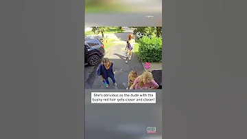 Woman Greets Red Headed Stranger In Her Driveway With Long Scream Shorts 