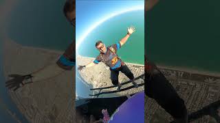 Guy Skydiving from Super Huey Helicopter Over a Beach
